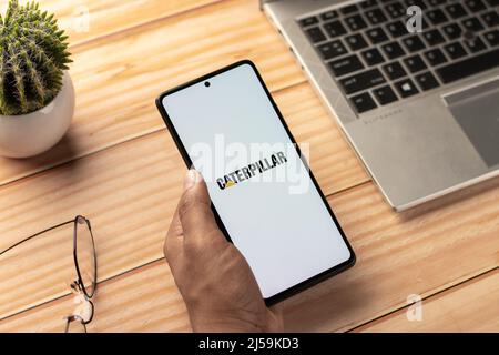 Caterpillar company logo on a website with blurry stock market developments  in the background, seen on a computer screen through a magnifying glass  Stock Photo - Alamy