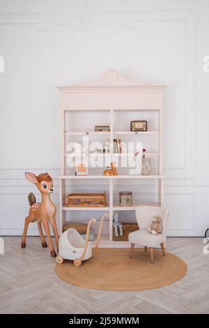Stylish scandinavian newborn baby room with toys, children's chair. Modern interior with grey background walls Stock Photo