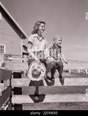 1940s 1950s SMILING TEEN GIRL HOLDING ON TO LITTLE BLONDE BOY AND STRAW HAT SITTING ON FARM FENCE WATCHING ACTIVITY IN FARMYARD - j1262 HAR001 HARS BROTHER OLD FASHION SISTER 1 JUVENILE COTTON PLEASED FAMILIES JOY LIFESTYLE FEMALES BROTHERS RURAL HEALTHINESS HOME LIFE COPY SPACE FRIENDSHIP HALF-LENGTH PERSONS FARMING MALES TEENAGE GIRL SIBLINGS CONFIDENCE DENIM SISTERS AGRICULTURE B&W ACTIVITY HAPPINESS CHEERFUL PROTECTION AND FARMERS LOW ANGLE SIBLING SMILES JOYFUL TEENAGED BLUE JEANS COOPERATION INFORMAL JUVENILES TOGETHERNESS TWILL BLACK AND WHITE CASUAL CAUCASIAN ETHNICITY FARMYARD HAR001 Stock Photo