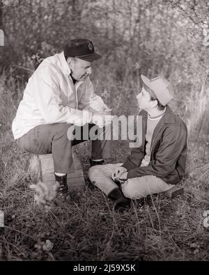1960s MAN FATHER AND BOY SON SITTING OUTDOORS IN AUTUMN FIELD HAVING A SERIOUS ADULT CONVERSATION TALKING AND LISTENING - j12985 HAR001 HARS PAIR LEAVES SUBURBAN OLD TIME NOSTALGIA OLD FASHION CONVERSATION 1 JUVENILE STYLE COMMUNICATION BALANCE TEAMWORK SONS FAMILIES JOY LIFESTYLE PARENTING RURAL HEALTHINESS HOME LIFE NATURE FULL-LENGTH PERSONS CARING MALES TEENAGE BOY SPIRITUALITY FATHERS B&W HAPPINESS WELLNESS DISCOVERY AND DADS RECREATION FATHER AND SON FALL SEASON PRIDE OPPORTUNITY AUTHORITY CONNECTION CONCEPTUAL TEENAGED FATHERS AND SONS MALE BONDING MAN TO MAN BASEBALL CAP GROWTH