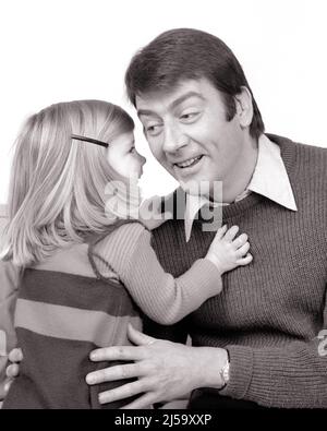 1970s PORTRAIT OF YOUNG BLONDE GIRL DAUGHTER FACE TO FACE WHISPERING SECRET IN SMILING MAN FATHER’S EAR - j14040 HAR001 HARS JUVENILE BLOND YOUNG ADULT PLEASED FAMILIES JOY LIFESTYLE PARENTING FEMALES HOME LIFE COPY SPACE FRIENDSHIP HALF-LENGTH DAUGHTERS PERSONS MALES FATHERS B&W BRUNETTE CHEERFUL AND DADS TELLING IN OF SMILES FACE TO FACE FATHER'S FATHER AND DAUGHTER JOYFUL JUVENILES YOUNG ADULT MAN BLACK AND WHITE CAUCASIAN ETHNICITY HAR001 OLD FASHIONED Stock Photo