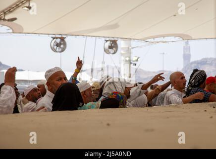 Pilgrims performing stoning ritual during hajj season in Makkah, Saudi Arabia Stock Photo