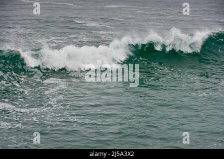 Surf Breaking. Waves break and crash on a rough sea. Stock Photo