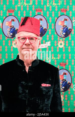 London, UK. 21st Apr, 2022. Gallery Director Christian Sulger-Buel with 'King Farouk Sudan - fabric pattern 3' (2022) 'Alternative Museum of The Sudan' is a solo exhibition of Amado Alfadni at the Sulgar-Buel Gallery of Contemporary African Art. Alfadni utilizes postcards, photographs and oral archives to reveal the relationship between colonialism and Black Africa, as well as the intermingled histories of Black Africa, Egypt and North Africa. It runs until 30th June, 2022. Credit: Imageplotter/Alamy Live News Stock Photo