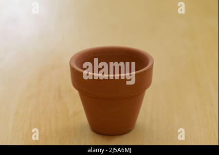 It's the season to be planting, a brown terracotta pot waits to be filled. Stock Photo