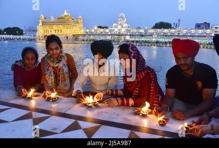 Amritsar, India. 21st Apr, 2022. AMRITSAR, INDIA - APRIL 21: Devotees light candles at Golden Temple on the occasion of the 400th birth anniversary of Guru Teg Bahadur on April 21, 2022 in Amritsar, India. (Photo by Sameer Sehgal/Hindustan Times/Sipa USA) Credit: Sipa USA/Alamy Live News Stock Photo