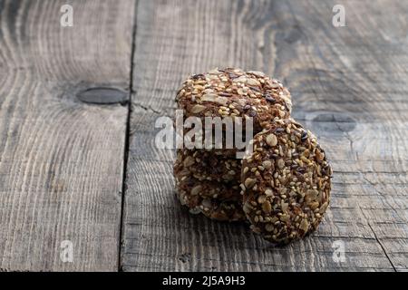 Healthy  fitness cookies from sunflower seeds and sesame seeds with flax seeds on wooden table Stock Photo
