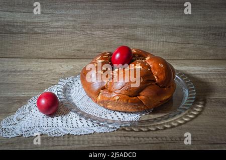 Easter traditional bread, greek tsoureki and red eggs Stock Photo