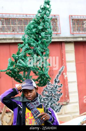 A Malagasy man selling Christmas decorations in the city center of Antananarivo, Madagascar. Stock Photo