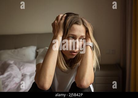 Tired Mother Suffering from experiencing postnatal depression. Health care mom motherhood stressful. Stay home during coronavirus covid-19 pandemic Stock Photo