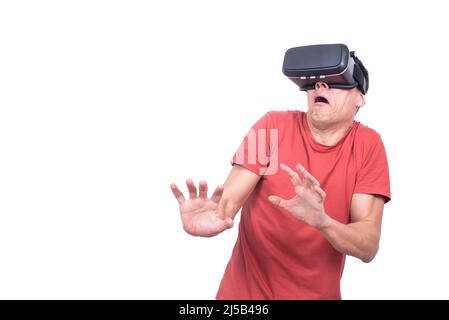 Scared man exploring virtual reality in studio Stock Photo