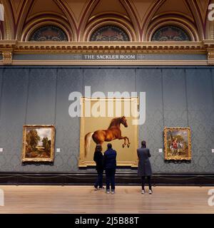 London, Greater London, England, April 09 2022: National Gallery interior as people admire artwork of a horse in The Sackler Room Stock Photo