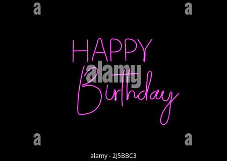 Photography of pink Neon light happy birthdat sign words lighted with electricity, girl birthday. Stock Photo