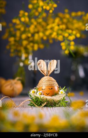 Easter bunny egg. Egg decorated with twine like a rabbit. Stock Photo