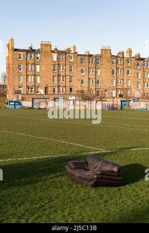 A sofa illegally dumped in a park in Edinburgh city centre Stock Photo