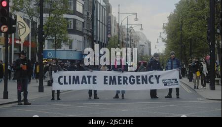 London, UK - 04 09 2022:  Extinction Rebellion climate protesters holding a banner, ‘Climate Emergency’, blocking a road in central London. Stock Photo