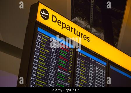 Departure board displaying time, destination cities and gate information in London Heathrow airport Stock Photo