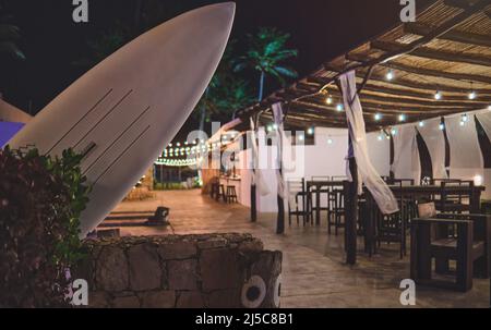 Image of table surf in front of abstract blurred restaurant lights background. Stock Photo