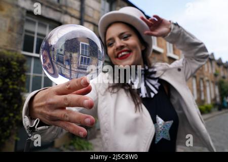 Jusztina Hermann with her crystal ball during a photocall in Circus Lane in Edinburgh ahead of Cirqulation: Future, Scotland’s Circus Cabaret Night at Assembly Roxy this weekend. Picture date: Friday April 22, 2022. Stock Photo