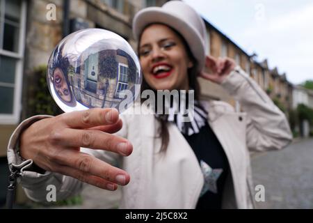 Jusztina Hermann with her crystal ball during a photocall in Circus Lane in Edinburgh ahead of Cirqulation: Future, Scotland’s Circus Cabaret Night at Assembly Roxy this weekend. Picture date: Friday April 22, 2022. Stock Photo