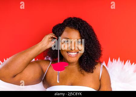 African Latin Cupid Woman in Wtite Top Bra Holding Bow and Arrow