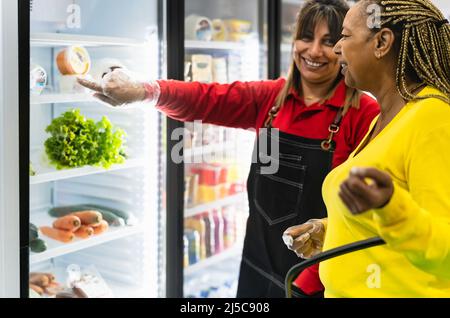 Senior African woman buying in supermarket Stock Photo