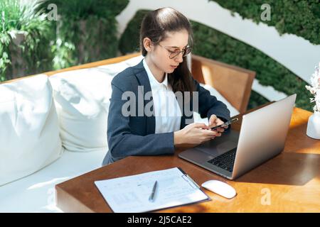 smiling businesswoman looking at the screen of her laptop. Stock Photo