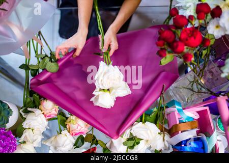 Cropped view of florist making flower bouquet close up Stock Photo