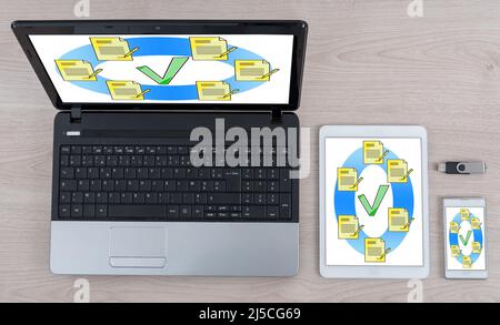 Document validation concept shown on different information technology devices Stock Photo