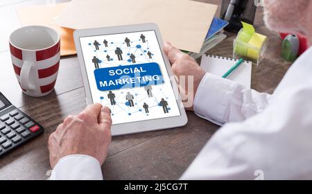 Social marketing concept shown on a tablet held by a man Stock Photo