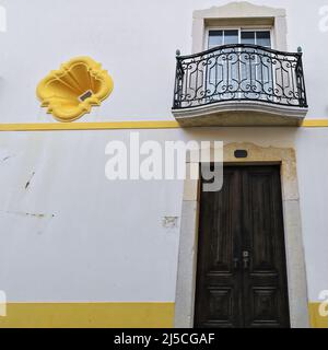 White façade-wood door-iron railing balcony-flared niche of Neoclassical townhouse. Lagos-Portugal-225 Stock Photo