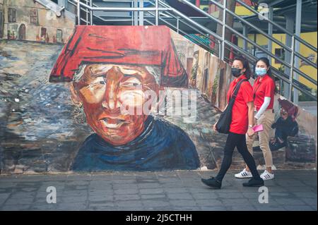 Oct. 16, 2020, Singapore, Republic of Singapore, Asia - Two Safe Distancing Ambassadors walk past a mural during a patrol amid the Corona pandemic (Covid-19) in the Chinatown neighborhood. They are making sure that people are complying with the standoff rule and that everyone is wearing their mouth masks at all times.   [Third party rights not with the photographer, no liability in case of claims by persons depicted or their depicted objects] [automated translation] Stock Photo