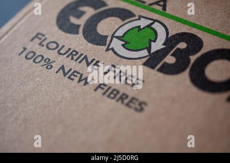 Recycling logo on sustainable compostable cardboard pizza box with text Flourine Free and 100 percent New Fibres. Shallow depth of field. Copenhagen, Stock Photo
