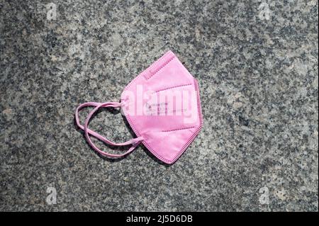 03/07/2022, Berlin, Germany, Europe - A used and discarded FFP2 protective mask against Corona (Covid-19) is lying on the floor. [automated translation] Stock Photo