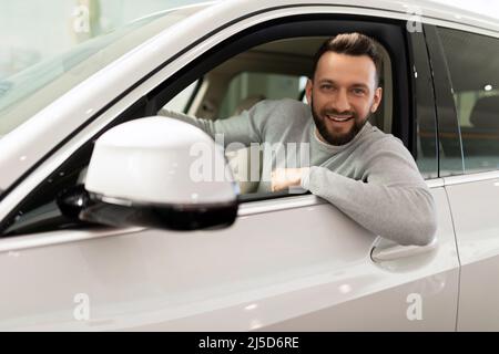 middle-aged man bought and insured a new car Stock Photo