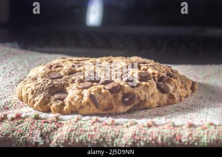 Big cookie with chocolate drops with natural light,homemade recipe concept. Stock Photo