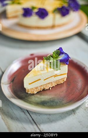 mango cheese cake on wood background,selective focus Stock Photo