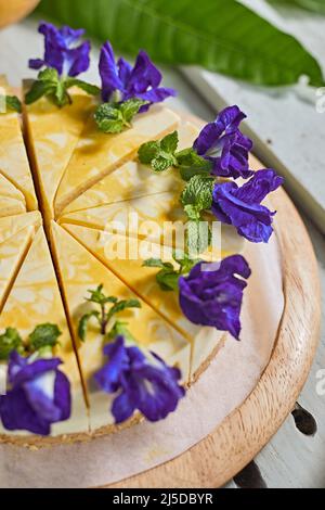 mango cheese cake on wood background,selective focus Stock Photo