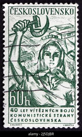 CZECHOSLOVAKIA - CIRCA 1961: a stamp printed in the Czechoslovakia shows Woman with Hammer and Sickle, circa 1961 Stock Photo