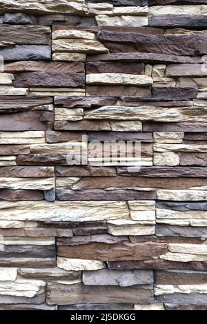 Wall stonework finishing from colorful natural stone trim as background front view close up Stock Photo