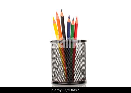Several colored pencils in a metal glass, close-up, isolated on a white background. Stock Photo