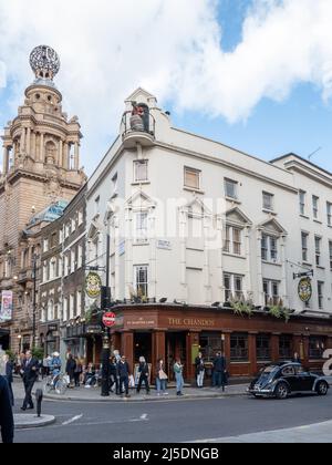 London, UK-29.10.21: people walking past The Chandos Pub on the crossroad of William IV Street and St. Martin's Lane