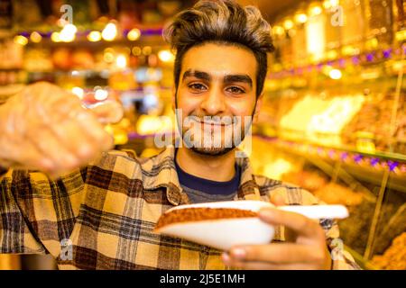 Turkish man selling tea in his own shop in Istambul bazar Stock Photo