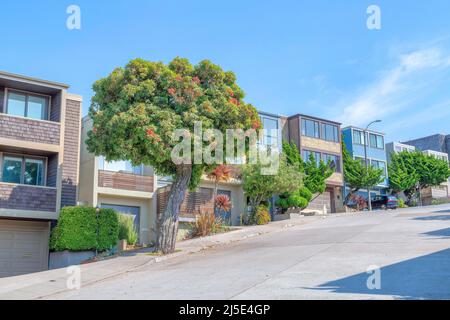 Neighborhood on a sloped land in San Francisco, California with concrete street pavement Stock Photo