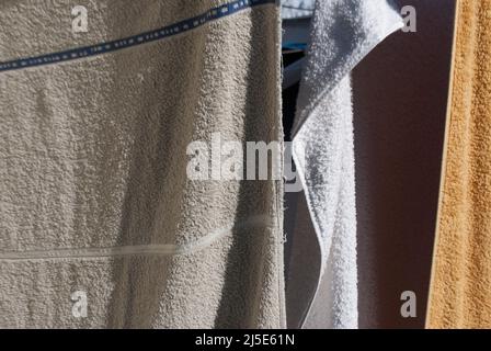 Close up of towels / washing hanging on a wall mounted cloths line in garden in Ruskington, Sleaford, England, UK Stock Photo