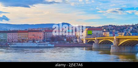 The bright cloudy sky over Danube River, historic embankment of Buda and the restored Margaret Bridge, Budapest, Hungary Stock Photo