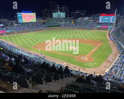 Chicago, Illinois, USA. 19th Apr, 2022. The landmark hand-operated  scoreboard at Wrigley Field, home of the Chicago Cubs, is shown Tuesday  evening April 19, 2022 when the Tampa Bay Rays were playing