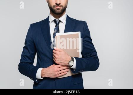partial view of economist in blue blazer holding folder isolated on grey Stock Photo