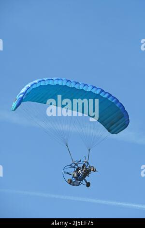 Motorized hang-glider, para-motor on a blue sky