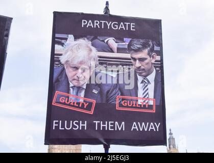 London, UK. 20th April 2022. A protester holds a signs calling Boris Johnson and Rishi Sunak 'guilty'. Anti-Boris Johnson protesters gathered in Parliament Square as pressure mounts on the Prime Minister over the Partygate scandal. Stock Photo